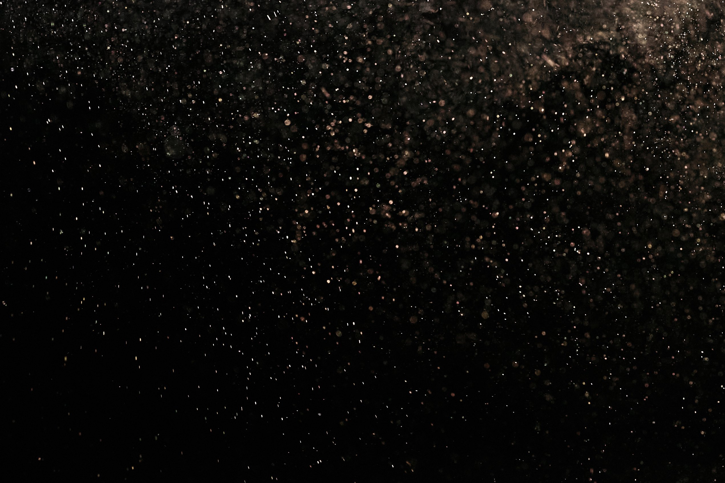 White Dust Particles on Black Background